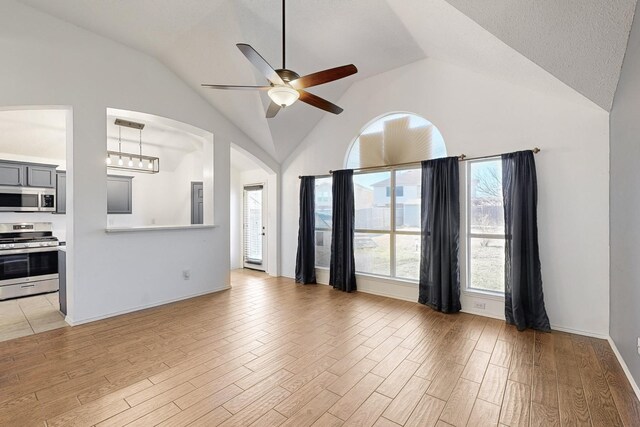 spare room with hardwood / wood-style floors, a tray ceiling, and a textured ceiling