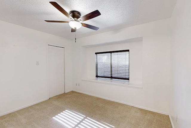 unfurnished room with ceiling fan, light hardwood / wood-style flooring, and a textured ceiling