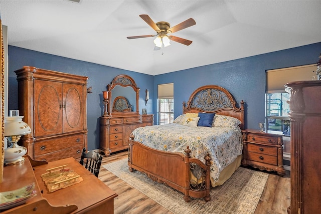 bedroom with ceiling fan and light hardwood / wood-style flooring