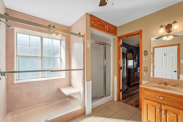 bathroom with ceiling fan, plenty of natural light, tile patterned flooring, and vanity