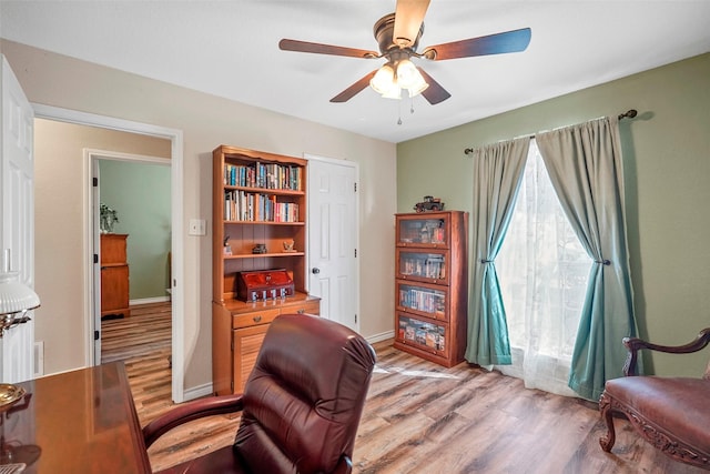 sitting room featuring ceiling fan and light wood-type flooring