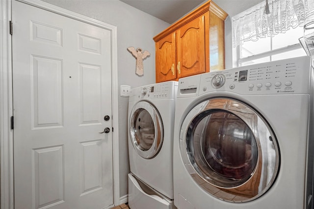 laundry area with cabinets and washing machine and dryer