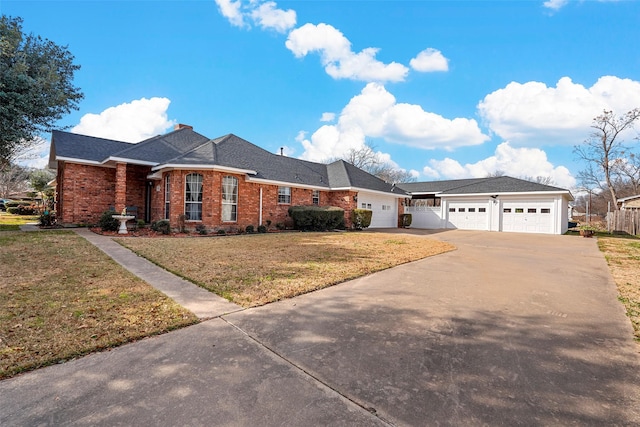 ranch-style home with a garage and a front lawn