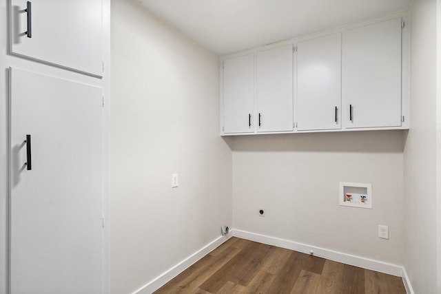 laundry area featuring cabinets, hookup for a washing machine, dark wood-type flooring, and hookup for an electric dryer