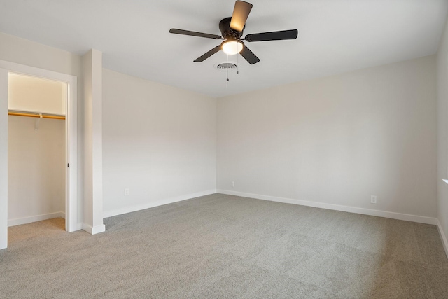 unfurnished bedroom featuring light carpet, a closet, and ceiling fan