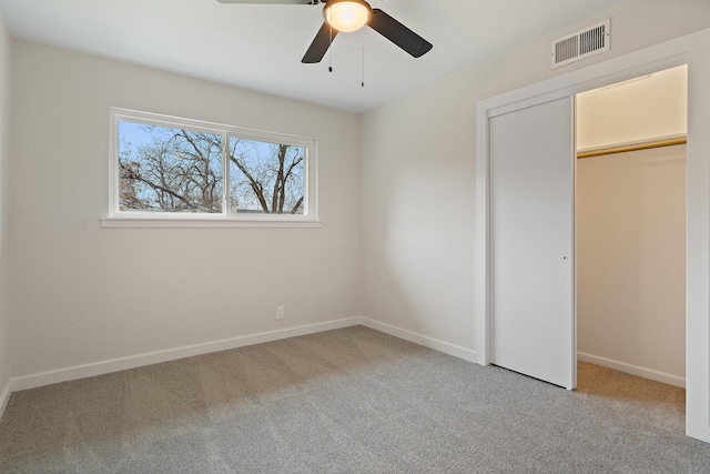 unfurnished bedroom featuring ceiling fan, carpet floors, and a closet