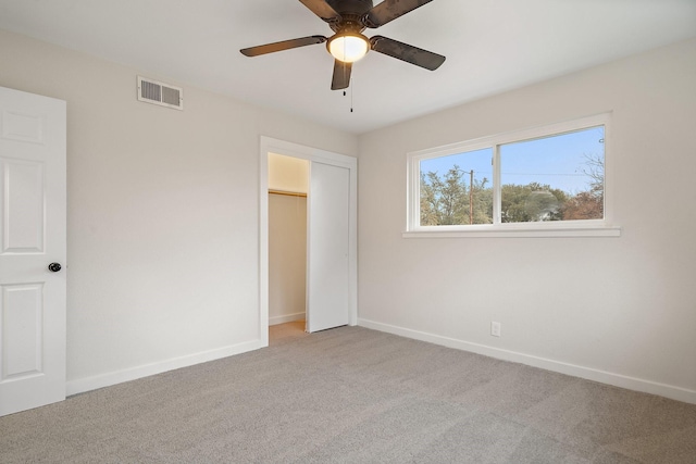 unfurnished bedroom with light carpet and ceiling fan