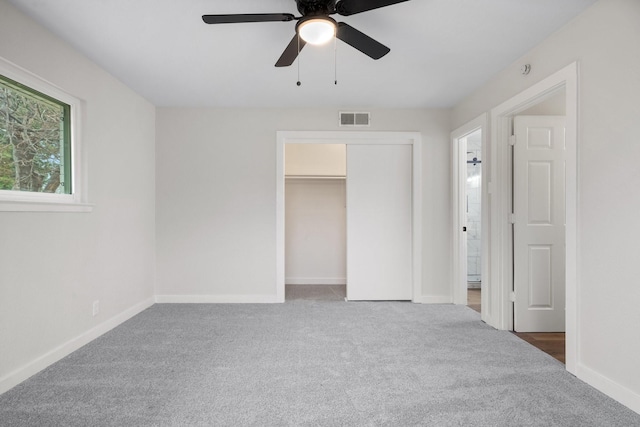 unfurnished bedroom with a closet, ceiling fan, and carpet flooring