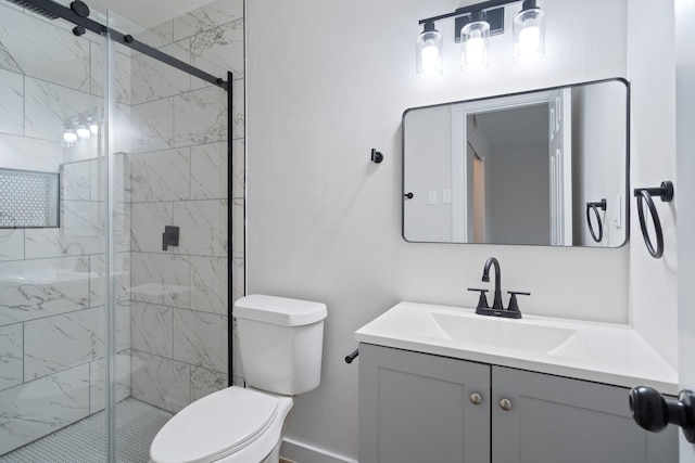 bathroom featuring vanity, a shower with door, and toilet