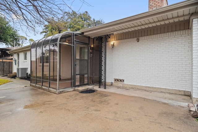 entrance to property with central AC and a patio area