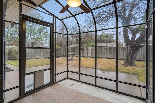 unfurnished sunroom featuring ceiling fan