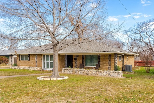 ranch-style house with cooling unit and a front yard