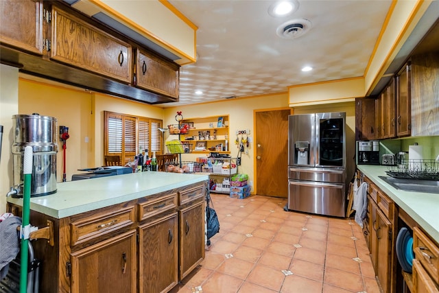 kitchen with stainless steel refrigerator with ice dispenser, crown molding, sink, and light tile patterned floors