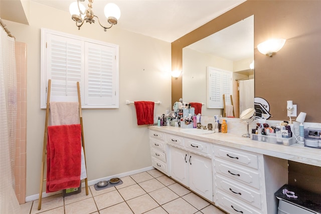 bathroom with a notable chandelier, vanity, and tile patterned floors