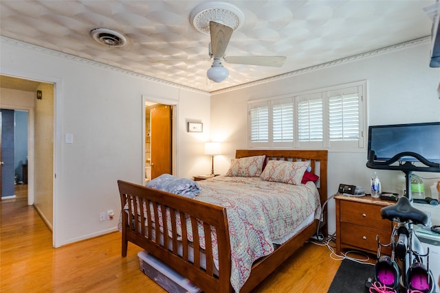 bedroom with ceiling fan and light wood-type flooring