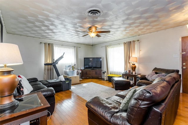 living room with ceiling fan, a healthy amount of sunlight, and light hardwood / wood-style floors