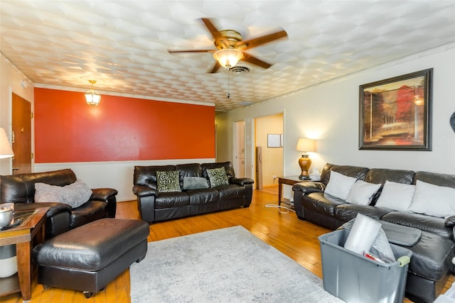 living room featuring ceiling fan and wood-type flooring