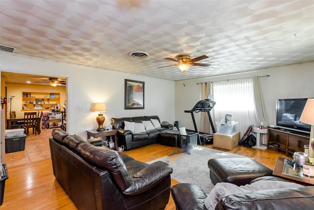 living room featuring light wood-type flooring and ceiling fan