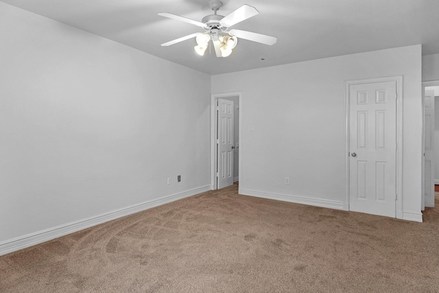 interior space with carpet, baseboards, and ceiling fan