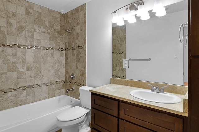 full bathroom with vanity, tiled shower / bath combo, and toilet