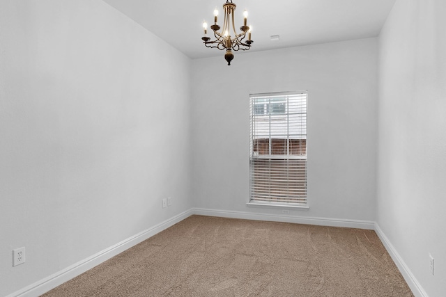 unfurnished room featuring carpet and an inviting chandelier