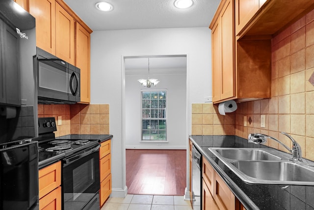 kitchen with light tile patterned flooring, sink, decorative backsplash, a notable chandelier, and black appliances