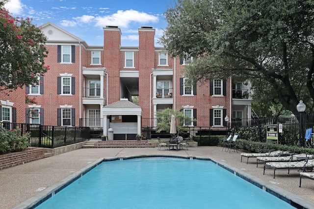 pool featuring a patio area and fence