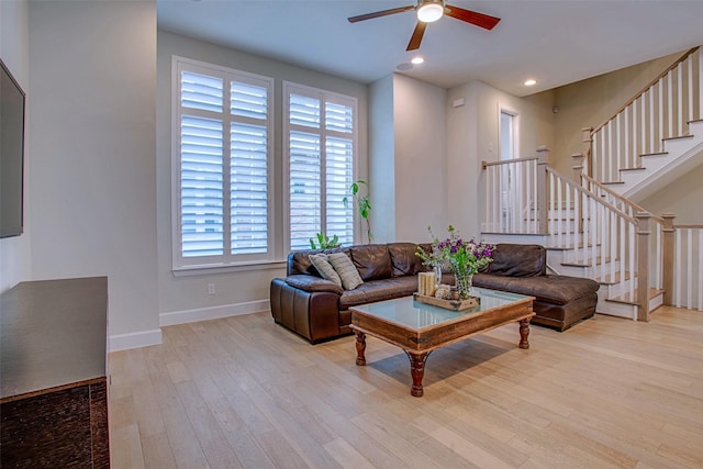 living room with ceiling fan and light wood-type flooring