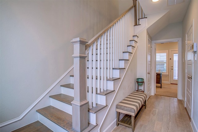 stairs featuring hardwood / wood-style floors