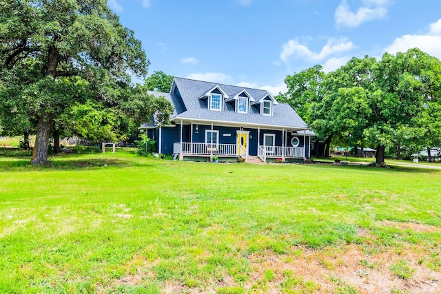 new england style home featuring covered porch and a front lawn