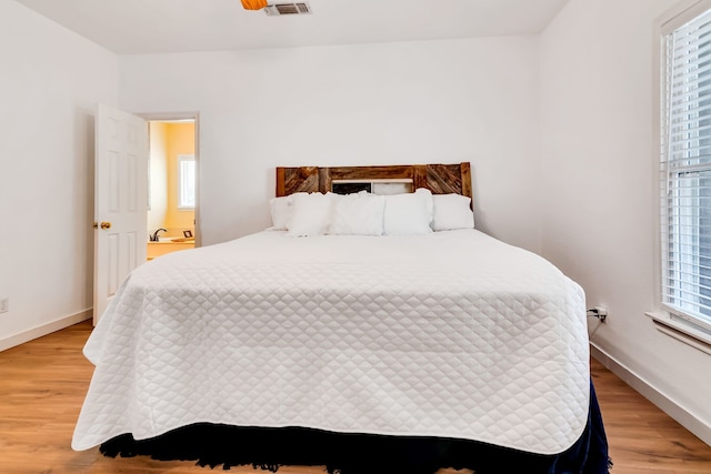 bedroom featuring light hardwood / wood-style floors and multiple windows