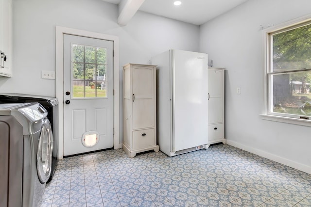 laundry area featuring cabinets and independent washer and dryer