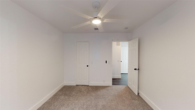 unfurnished bedroom featuring ceiling fan and carpet floors