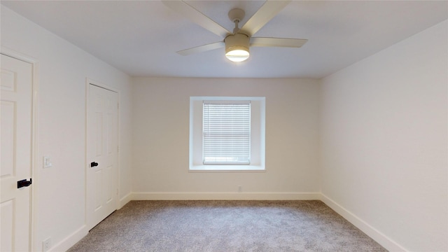 spare room featuring carpet floors and ceiling fan