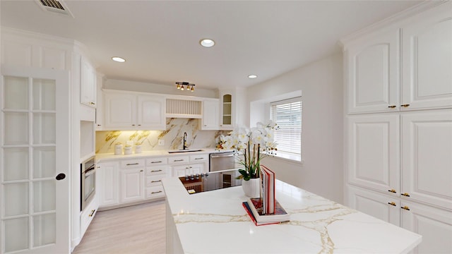 kitchen with stainless steel appliances, sink, and white cabinets