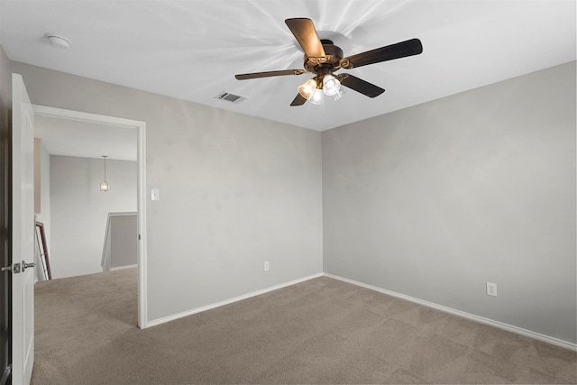 spare room featuring ceiling fan and carpet flooring