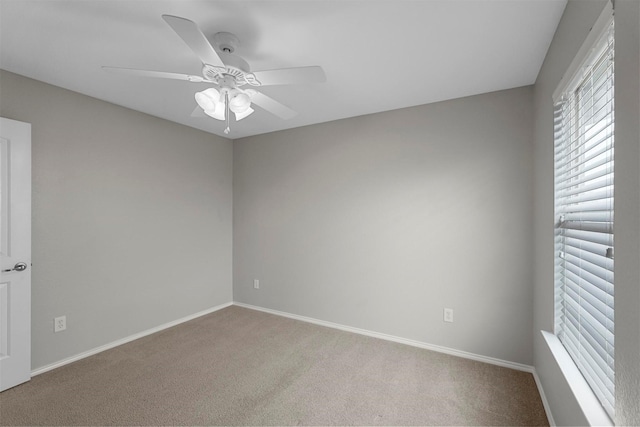 spare room featuring light carpet and ceiling fan