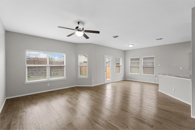 unfurnished living room with dark wood-type flooring and ceiling fan