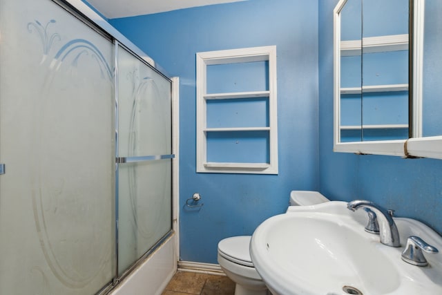 full bathroom with sink, shower / bath combination with glass door, and toilet