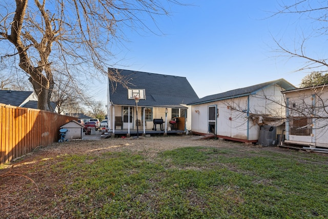 rear view of house featuring a yard