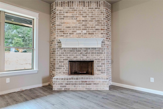 unfurnished living room featuring hardwood / wood-style floors and a fireplace