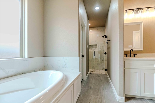 bathroom featuring vanity and plus walk in shower