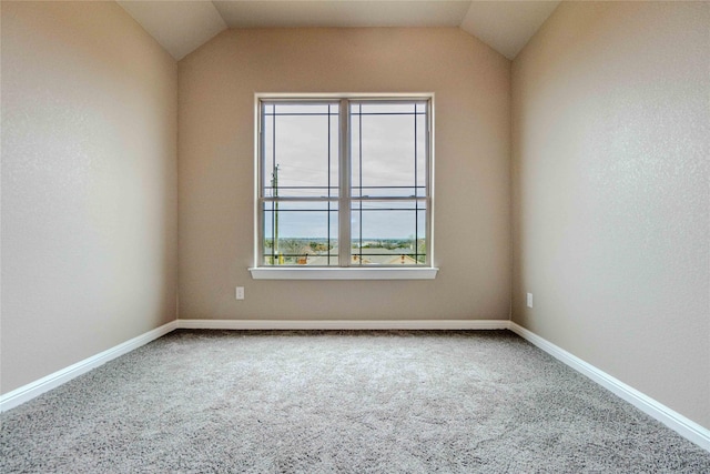 unfurnished room featuring lofted ceiling and carpet flooring