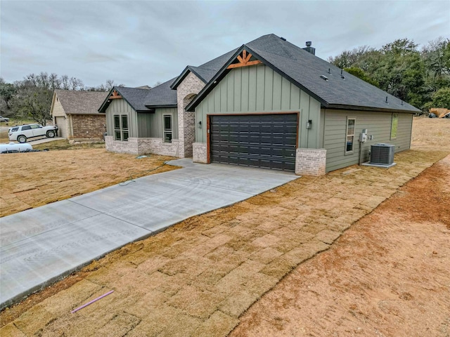 view of front of house with a garage and central AC