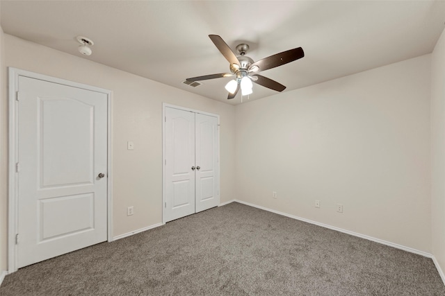 unfurnished bedroom featuring a closet, ceiling fan, and carpet flooring