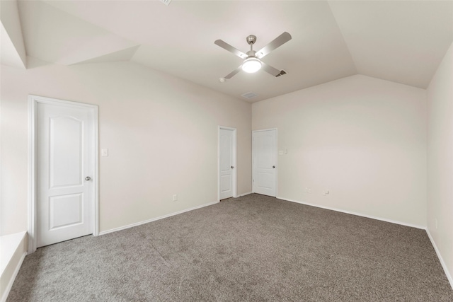 empty room featuring lofted ceiling, carpet, and ceiling fan