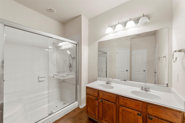 bathroom with vanity, wood-type flooring, and walk in shower