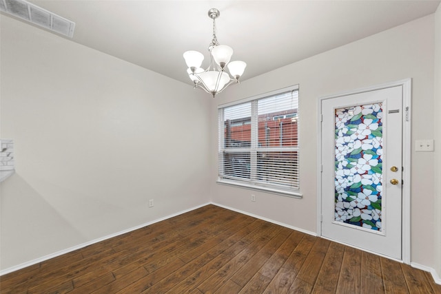 interior space featuring an inviting chandelier and dark hardwood / wood-style flooring