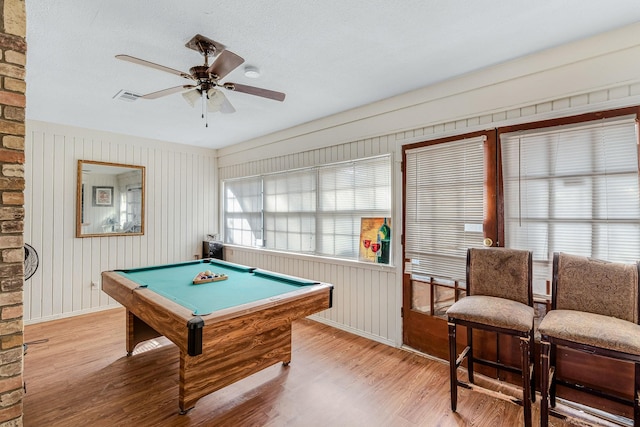 rec room with ceiling fan, pool table, light hardwood / wood-style flooring, and a textured ceiling