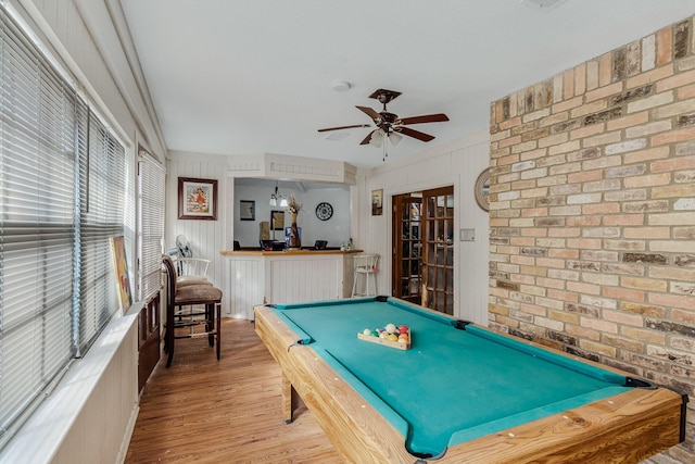 rec room featuring pool table, light hardwood / wood-style flooring, ceiling fan, and brick wall